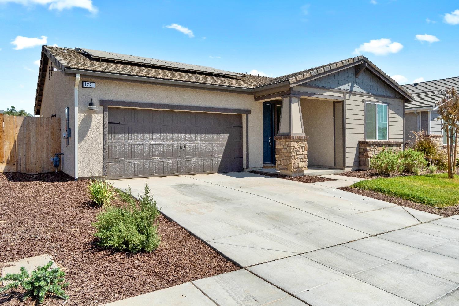 1241 Peters Road Madera, CA 93636 - Photo 5 of 37 a front view of a house with a yard and garage