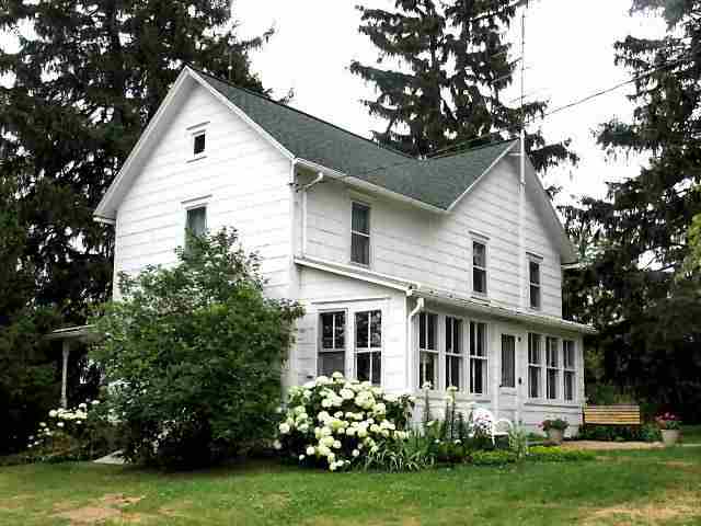 8942 North Unity Road Winslow, IL 61089 - Photo 1 of 12 a view of a house with garden and trees