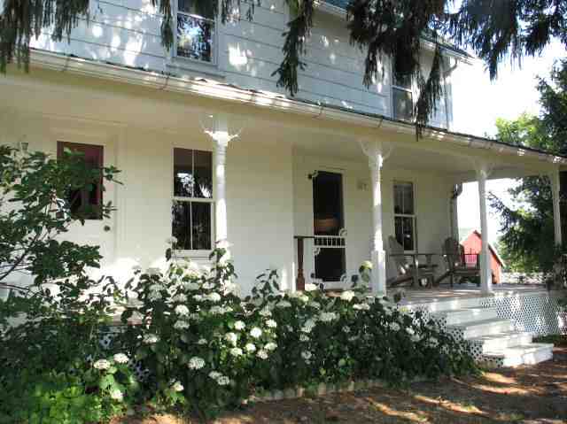 8942 North Unity Road Winslow, IL 61089 - Photo 2 of 12 front view of house with a potted plant