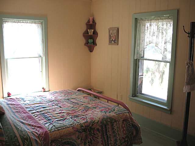 8942 North Unity Road Winslow, IL 61089 - Photo 8 of 12 a bed sitting in a bedroom next to a window