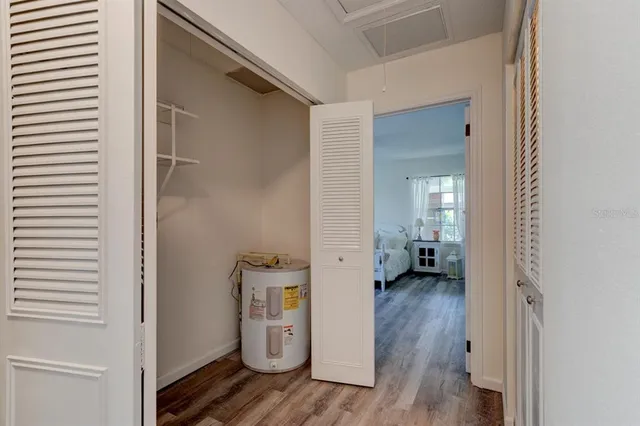 a view of a hallway with wooden floor and a living room