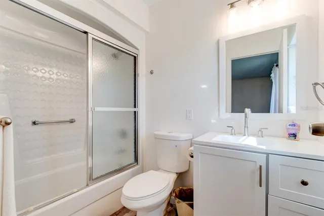 a bathroom with a toilet a sink and a mirror