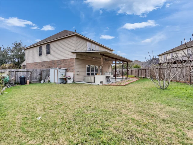 a backyard of a house with table and chairs