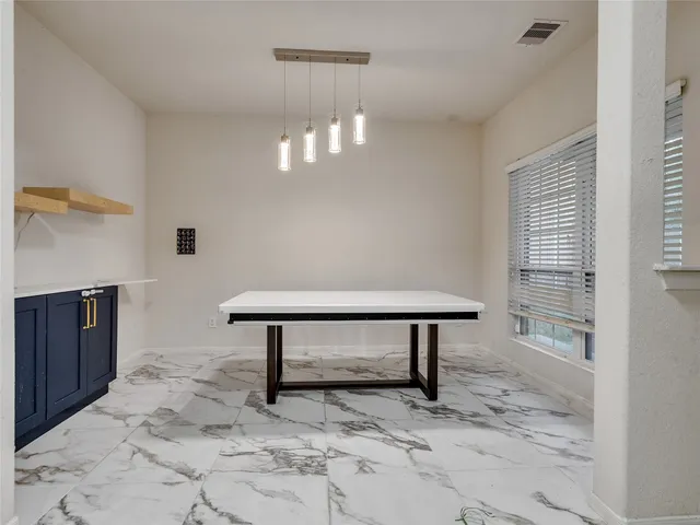 a kitchen with granite countertop a sink cabinets and stainless steel appliances