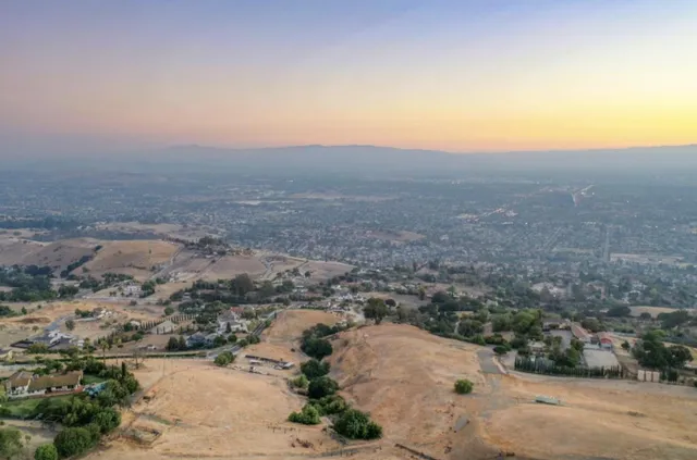 an aerial view of residential houses with city view