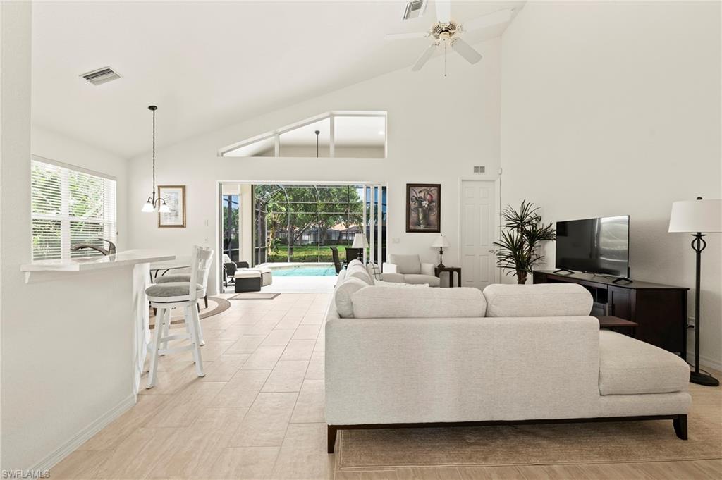 17887 Modena Road Miromar Lakes, FL 33913 - Photo 12 of 50 a living room with furniture and a flat screen tv