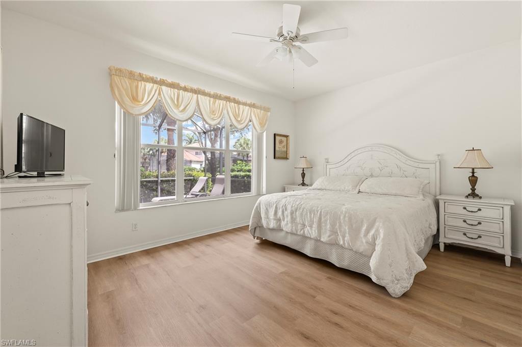 17887 Modena Road Miromar Lakes, FL 33913 - Photo 13 of 50 a bedroom with a large bed and a flat tv screen on dresser