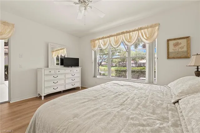 a large bedroom with a bed and a tv on the dresser