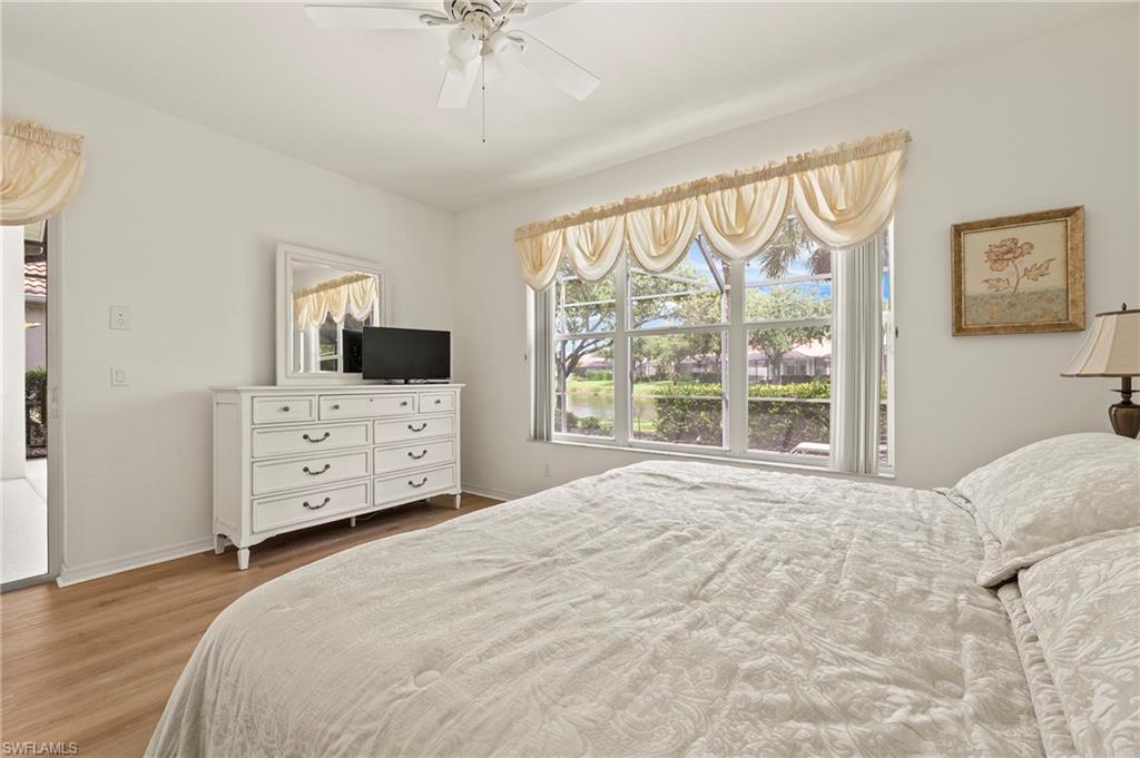 17887 Modena Road Miromar Lakes, FL 33913 - Photo 14 of 50 a large bedroom with a bed and a tv on the dresser