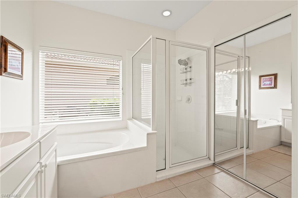 17887 Modena Road Miromar Lakes, FL 33913 - Photo 16 of 50 a bathroom with a bathtub and a shower