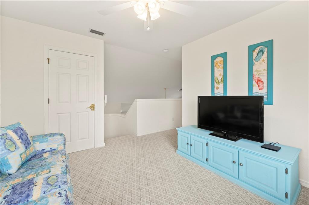 17887 Modena Road Miromar Lakes, FL 33913 - Photo 21 of 50 a bedroom with furniture and a flat screen tv