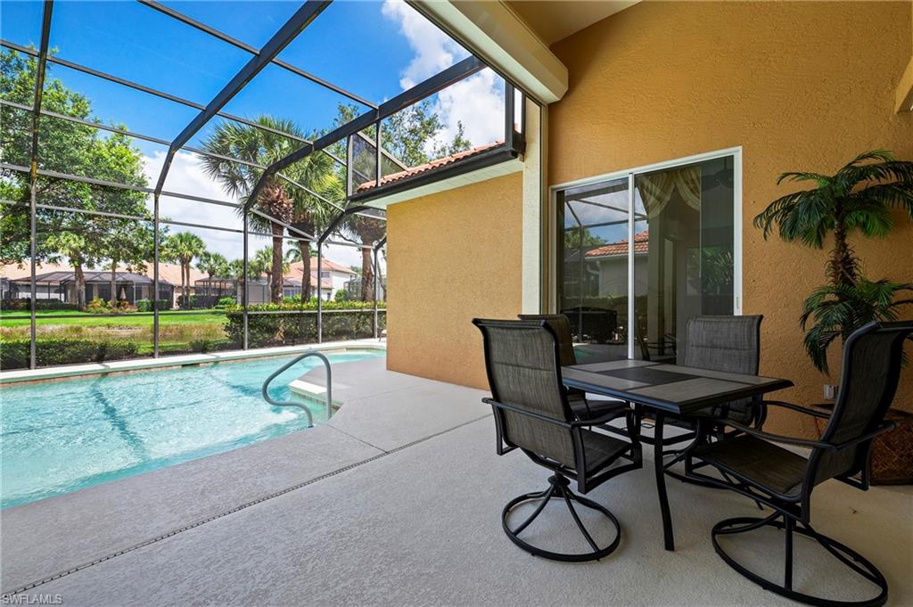 17887 Modena Road Miromar Lakes, FL 33913 - Photo 25 of 50 a view of swimming pool with outdoor seating and city view