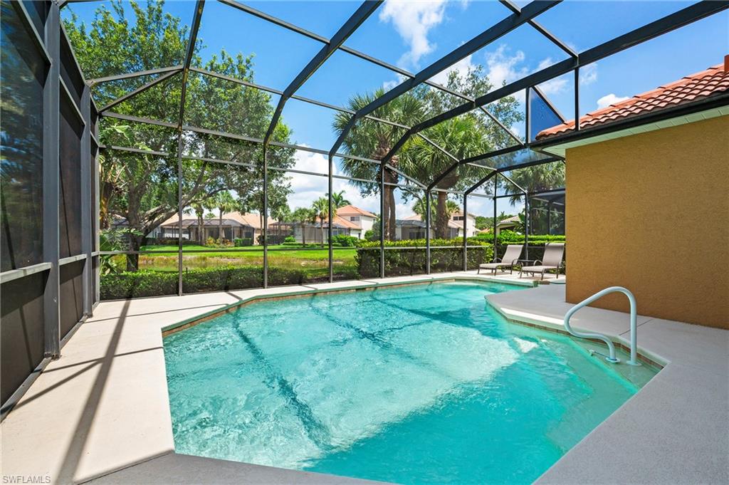 17887 Modena Road Miromar Lakes, FL 33913 - Photo 27 of 50 a view of backyard with a table and chairs
