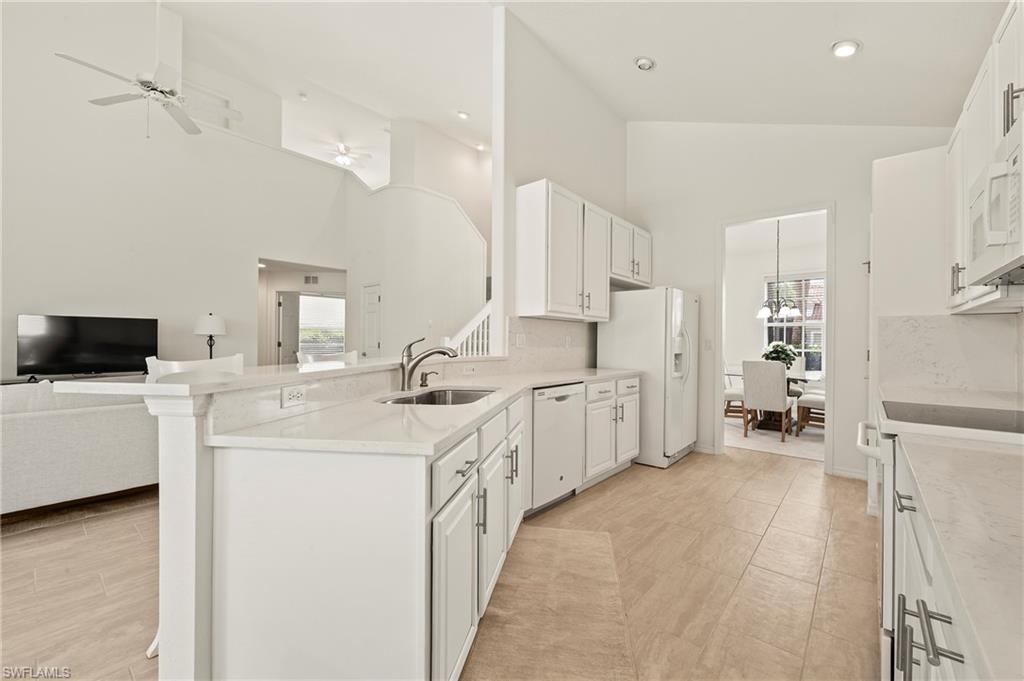 17887 Modena Road Miromar Lakes, FL 33913 - Photo 5 of 50 a kitchen with white cabinets and chairs