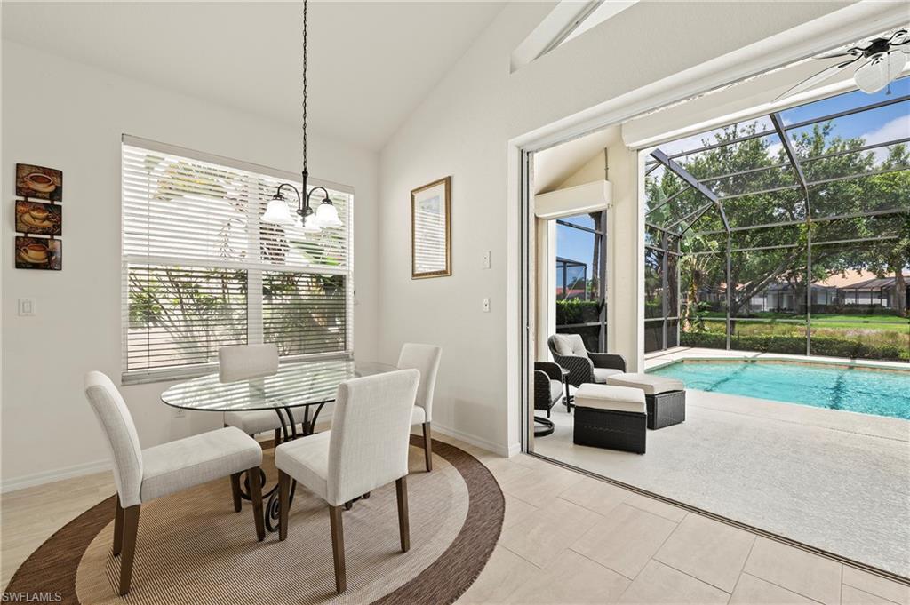 17887 Modena Road Miromar Lakes, FL 33913 - Photo 6 of 50 a dining room with furniture a chandelier and garden view