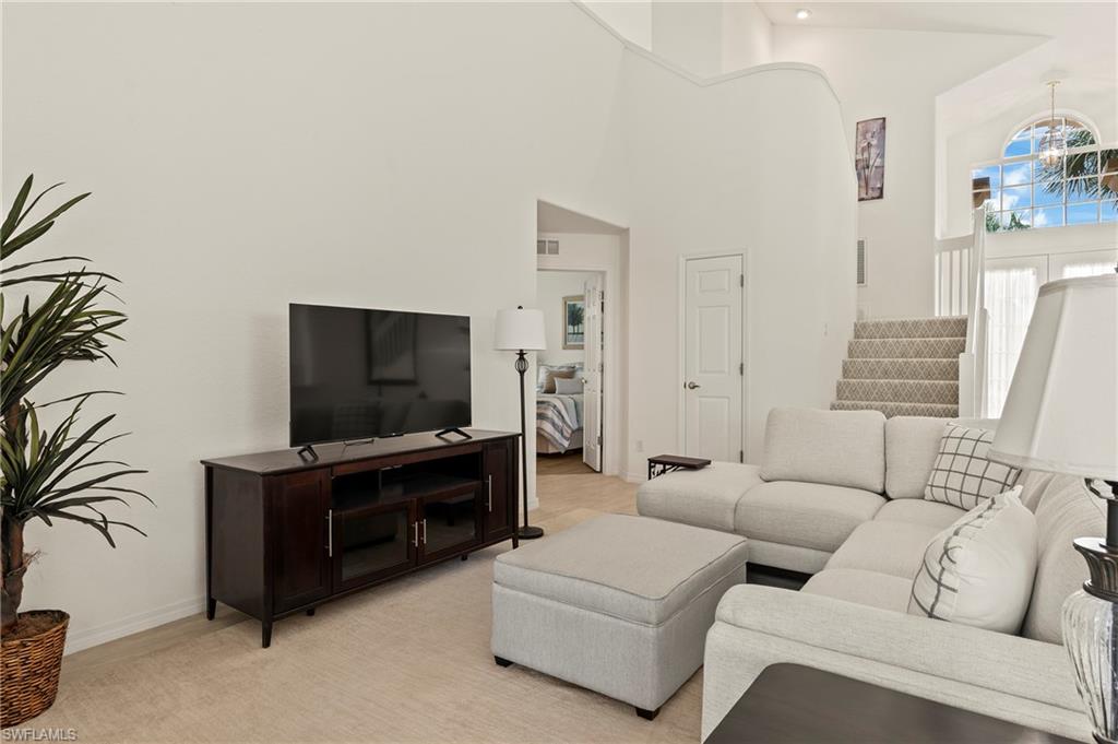 17887 Modena Road Miromar Lakes, FL 33913 - Photo 8 of 50 a living room with furniture and a flat screen tv