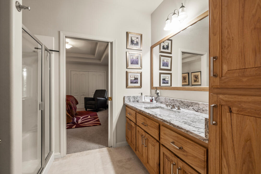 11629 Merganser Road Klamath Falls, OR 97601 - Photo 20 of 50 a en suite bathroom with a granite countertop sink a mirror and a shower