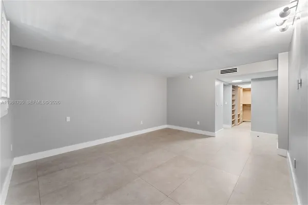 a view of walk in closet with empty racks