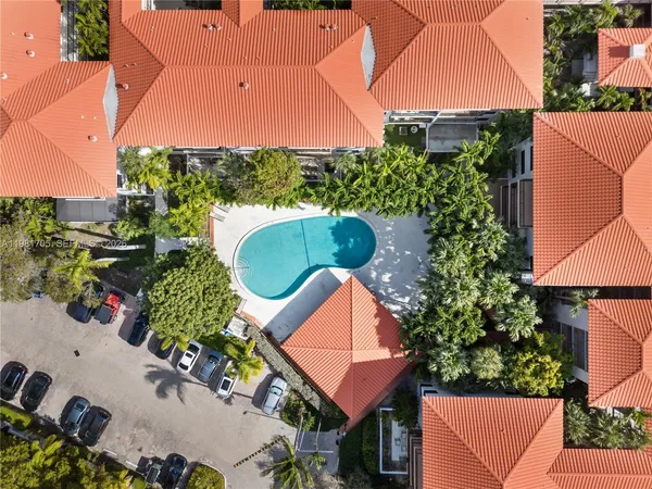 an aerial view of a house with a yard and plants