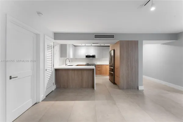 a kitchen with a sink stainless steel appliances and cabinets