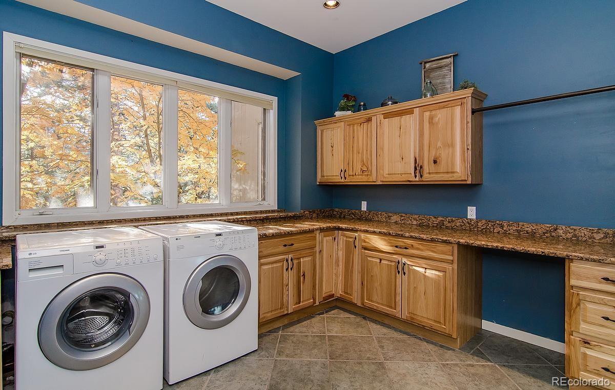 955 Castle Ridge Road Golden, CO 80401 - Photo 16 of 27 a utility room with sink dryer and washer