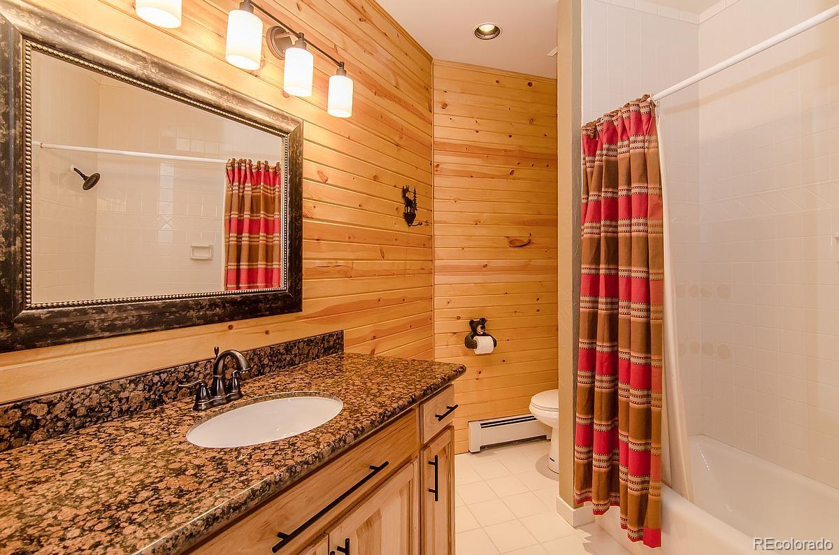 955 Castle Ridge Road Golden, CO 80401 - Photo 20 of 27 a bathroom with a sink and a mirror
