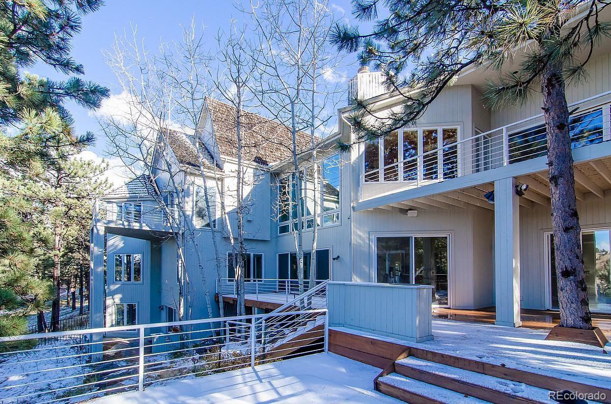 955 Castle Ridge Road Golden, CO 80401 - Photo 22 of 27 a view of the house with a tree beside it