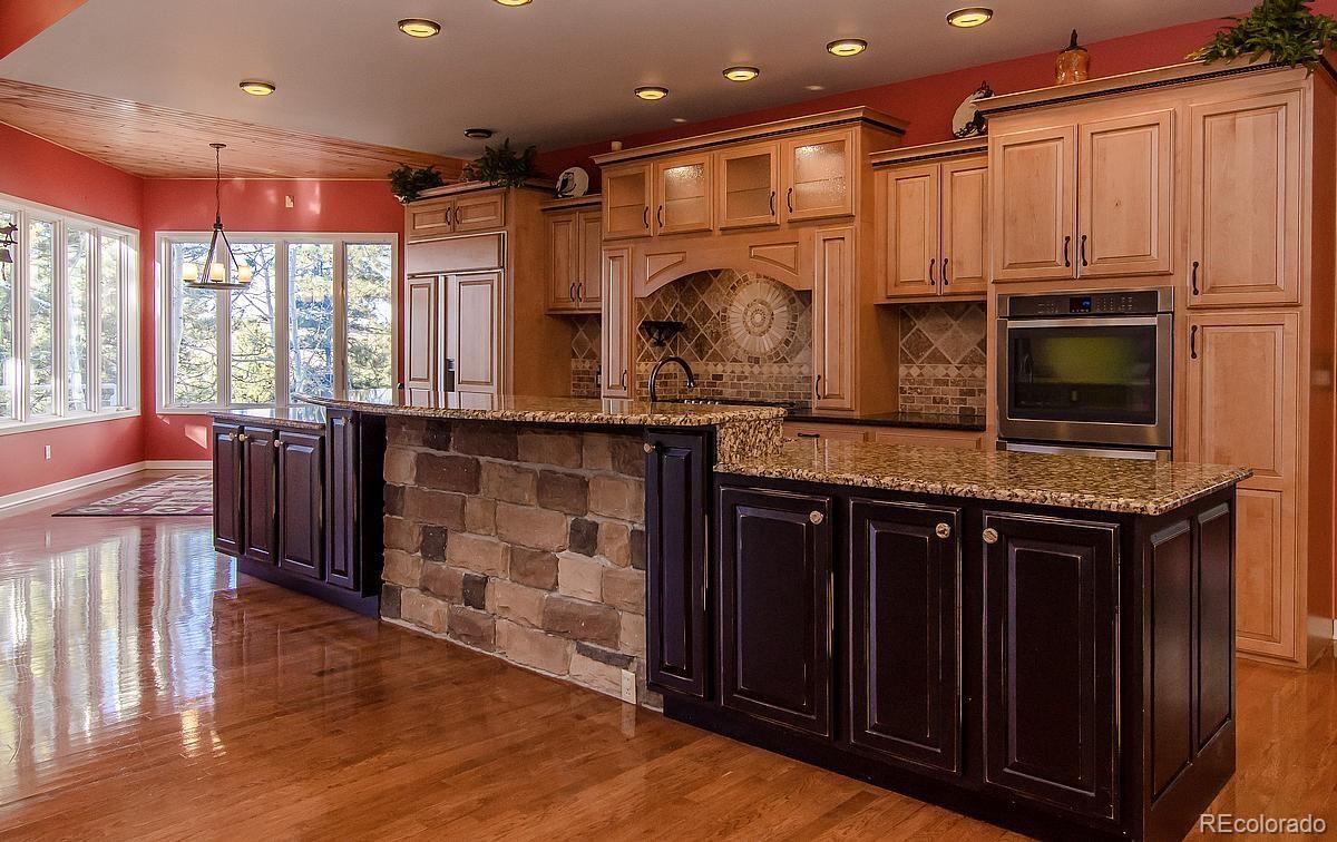 955 Castle Ridge Road Golden, CO 80401 - Photo 5 of 27 a kitchen with stainless steel appliances granite countertop a stove and a sink