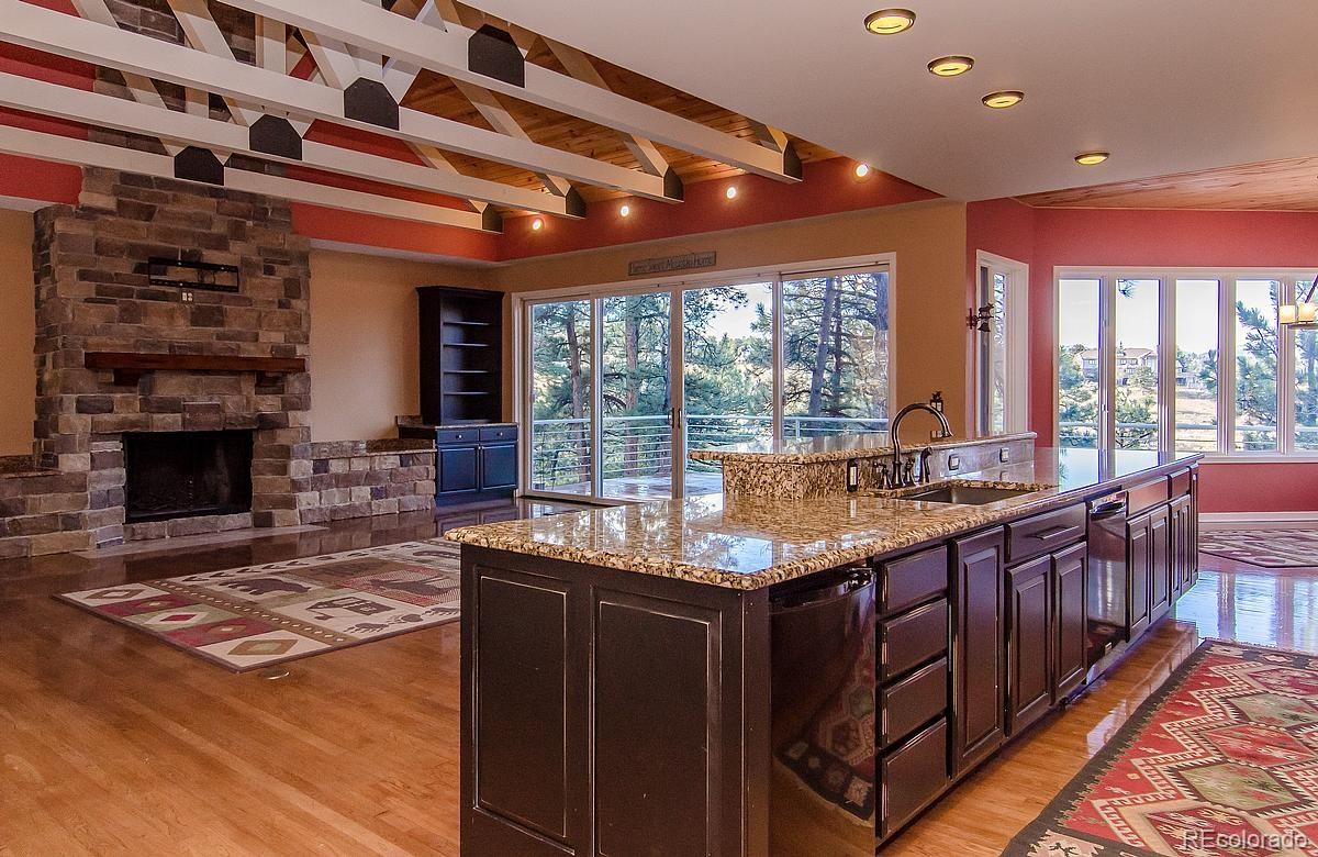 955 Castle Ridge Road Golden, CO 80401 - Photo 7 of 27 a kitchen with granite countertop sink stove and cabinets