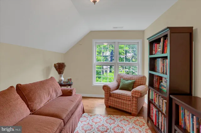 a view of staircase with lots of frames on wall and a window