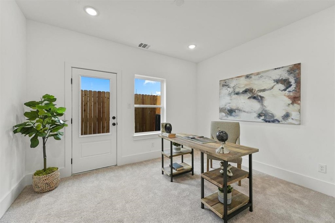 a living room with furniture and potted plant