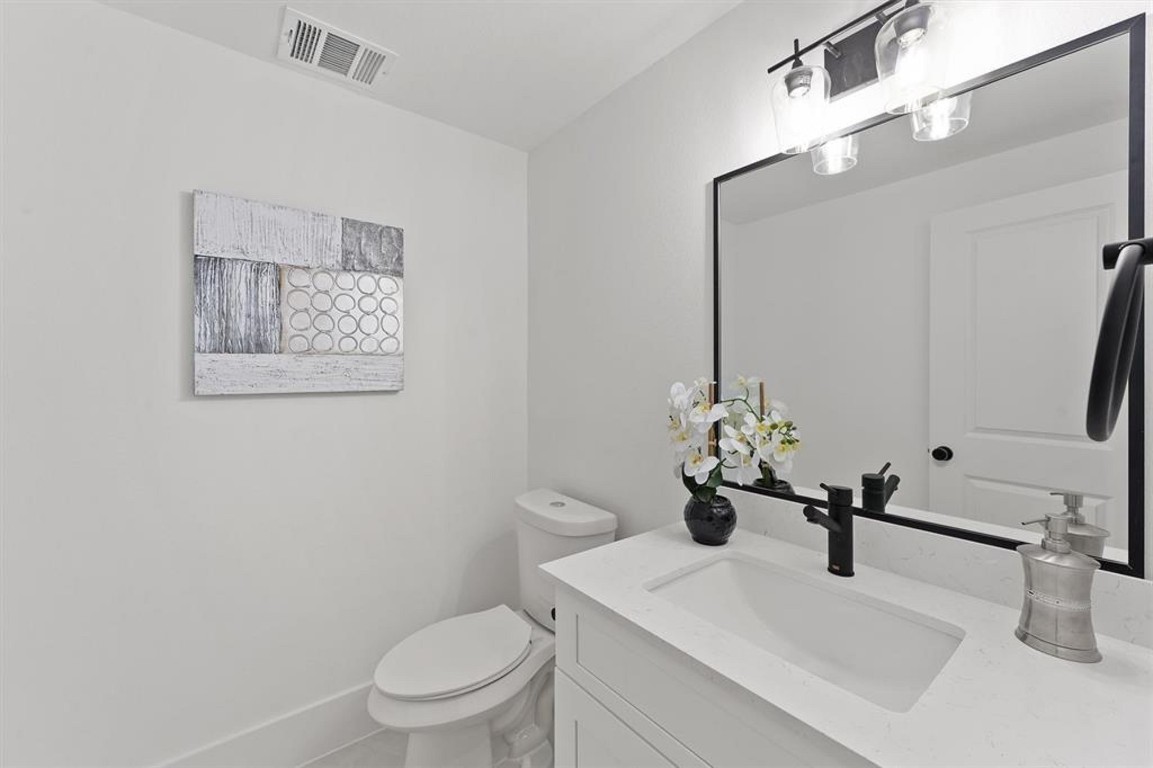 1207 Cavalcade Street, Unit B Houston, TX 77009 - Photo 12 of 20 a bathroom with a sink a toilet and mirror