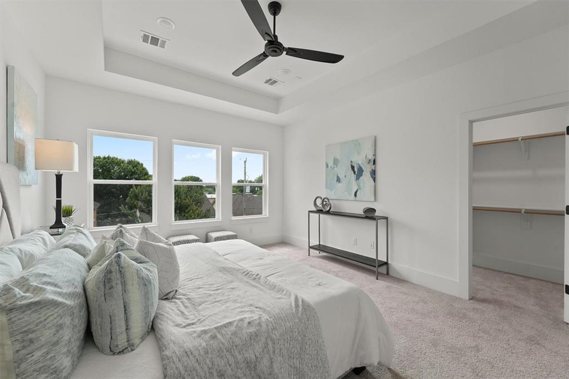 1207 Cavalcade Street, Unit B Houston, TX 77009 - Photo 14 of 20 a spacious bedroom with a large bed and a chandelier
