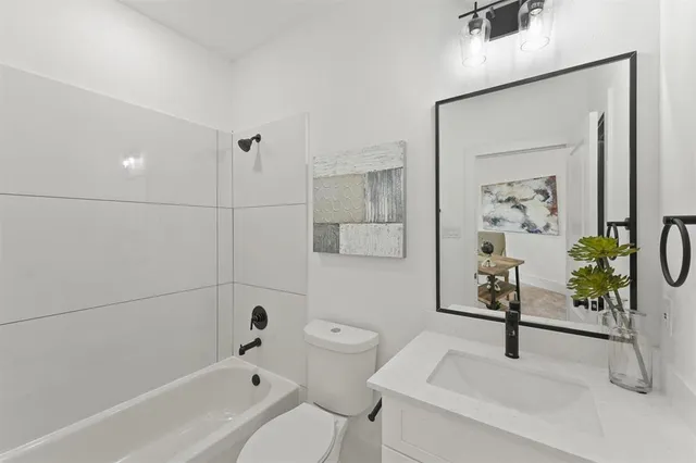 a bathroom with a shower a toilet and a bathtub