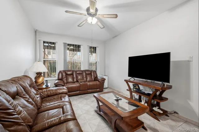 a spacious bedroom with a bed and a flat screen tv