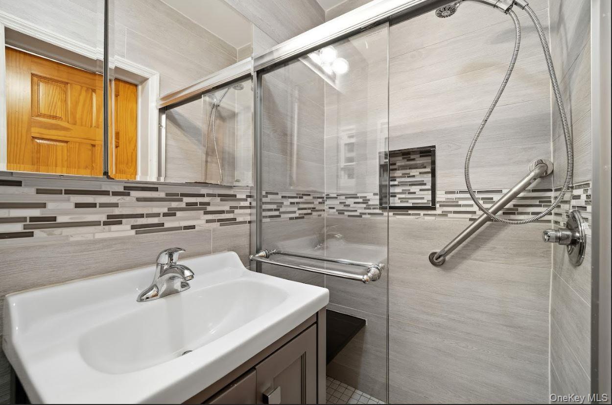 20-15 Menahan Street Queens, NY 11385 - Photo 18 of 41 a bathroom with a sink and a mirror