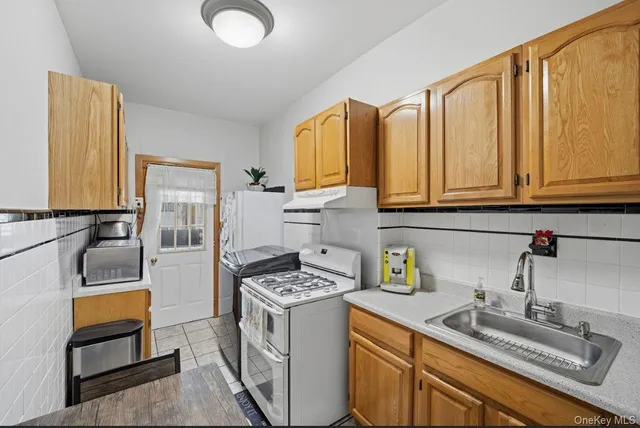 a kitchen with a stove and a window