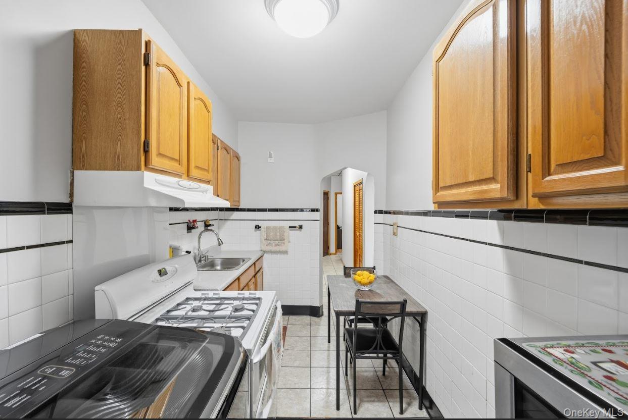 20-15 Menahan Street Queens, NY 11385 - Photo 21 of 41 a kitchen with a stove and a window