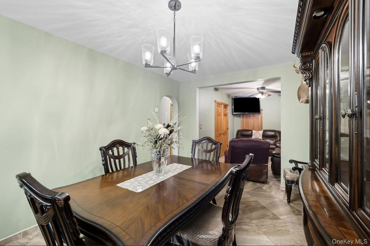 20-15 Menahan Street Queens, NY 11385 - Photo 23 of 41 a view of a dining room with furniture and a chandelier