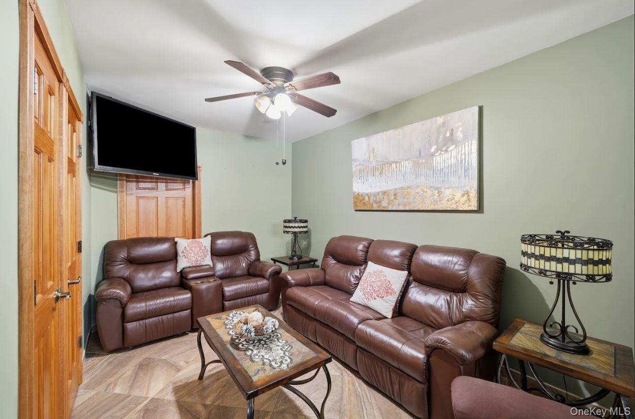 20-15 Menahan Street Queens, NY 11385 - Photo 24 of 41 a living room with furniture a flat screen tv and a window