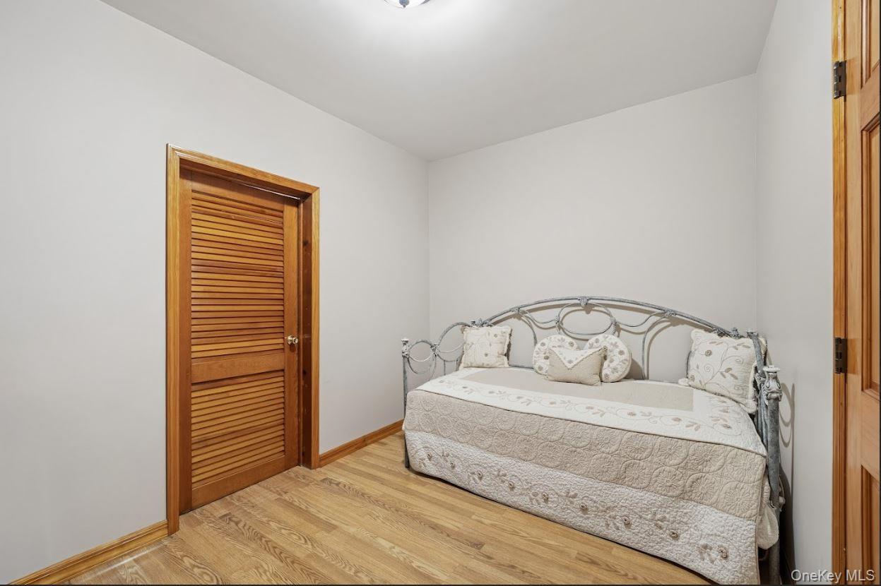 20-15 Menahan Street Queens, NY 11385 - Photo 28 of 41 a large white bed in a white room