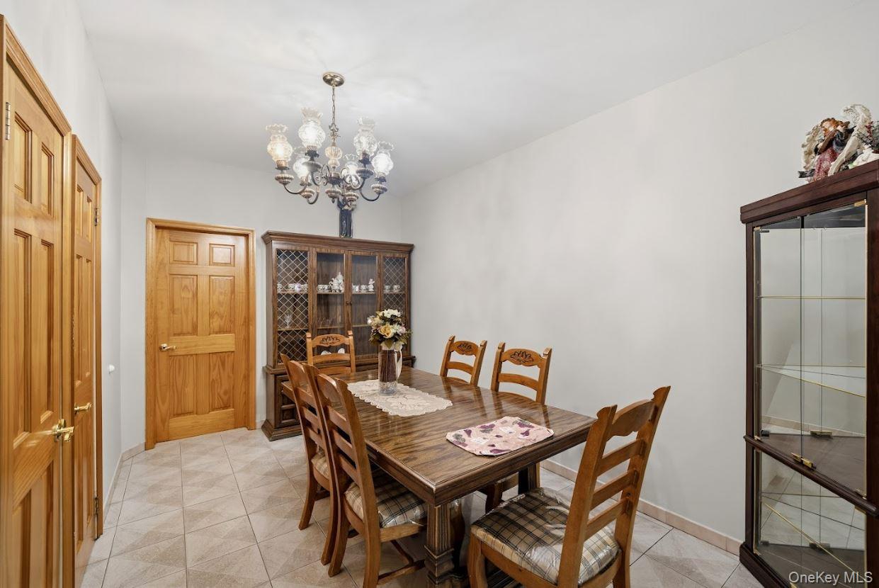 20-15 Menahan Street Queens, NY 11385 - Photo 9 of 41 a view of a dining room with furniture and chandelier