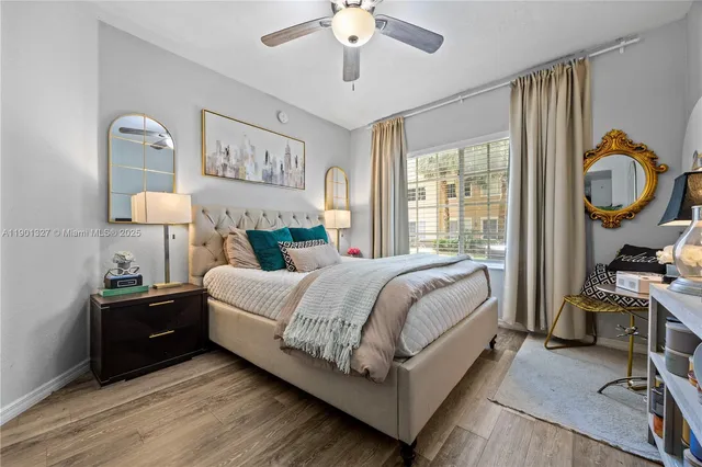 a spacious bedroom with a bed and a chandelier
