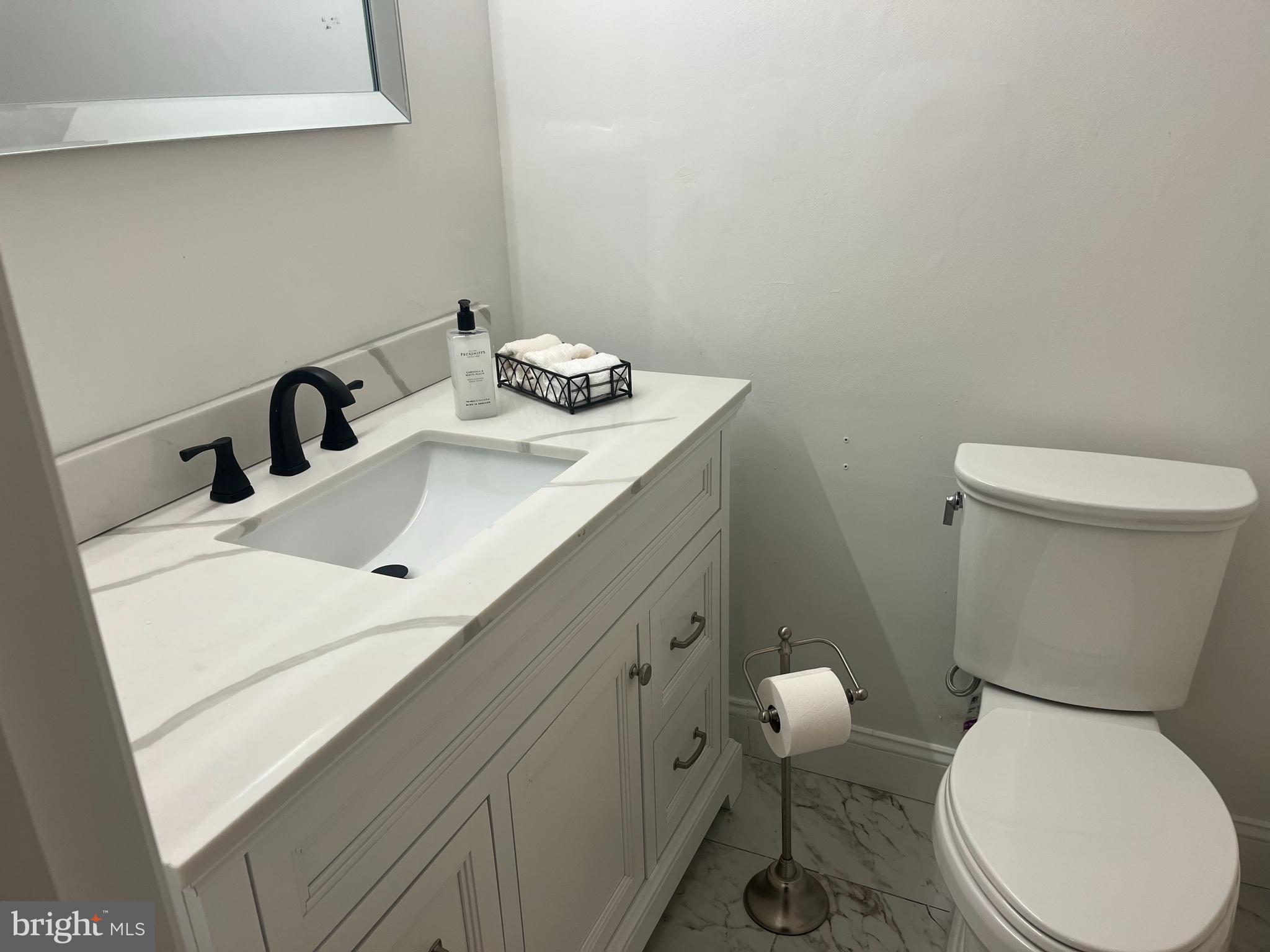 20 Conshohocken State Road, Unit 611 Bala Cynwyd, PA 19004 - Photo 12 of 25 a bathroom with a toilet sink and mirror