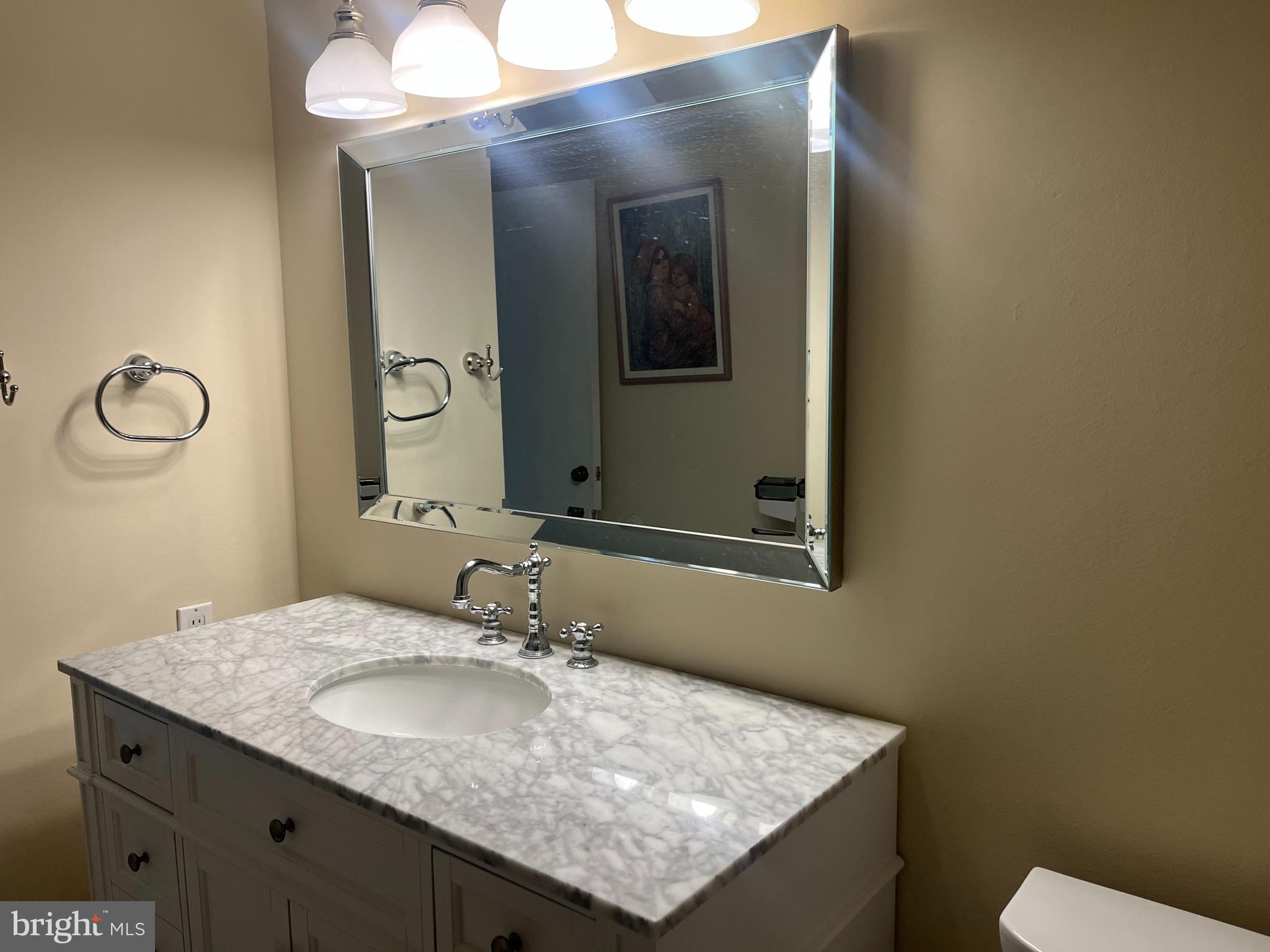 20 Conshohocken State Road, Unit 611 Bala Cynwyd, PA 19004 - Photo 14 of 25 a bathroom with a granite countertop sink and a mirror
