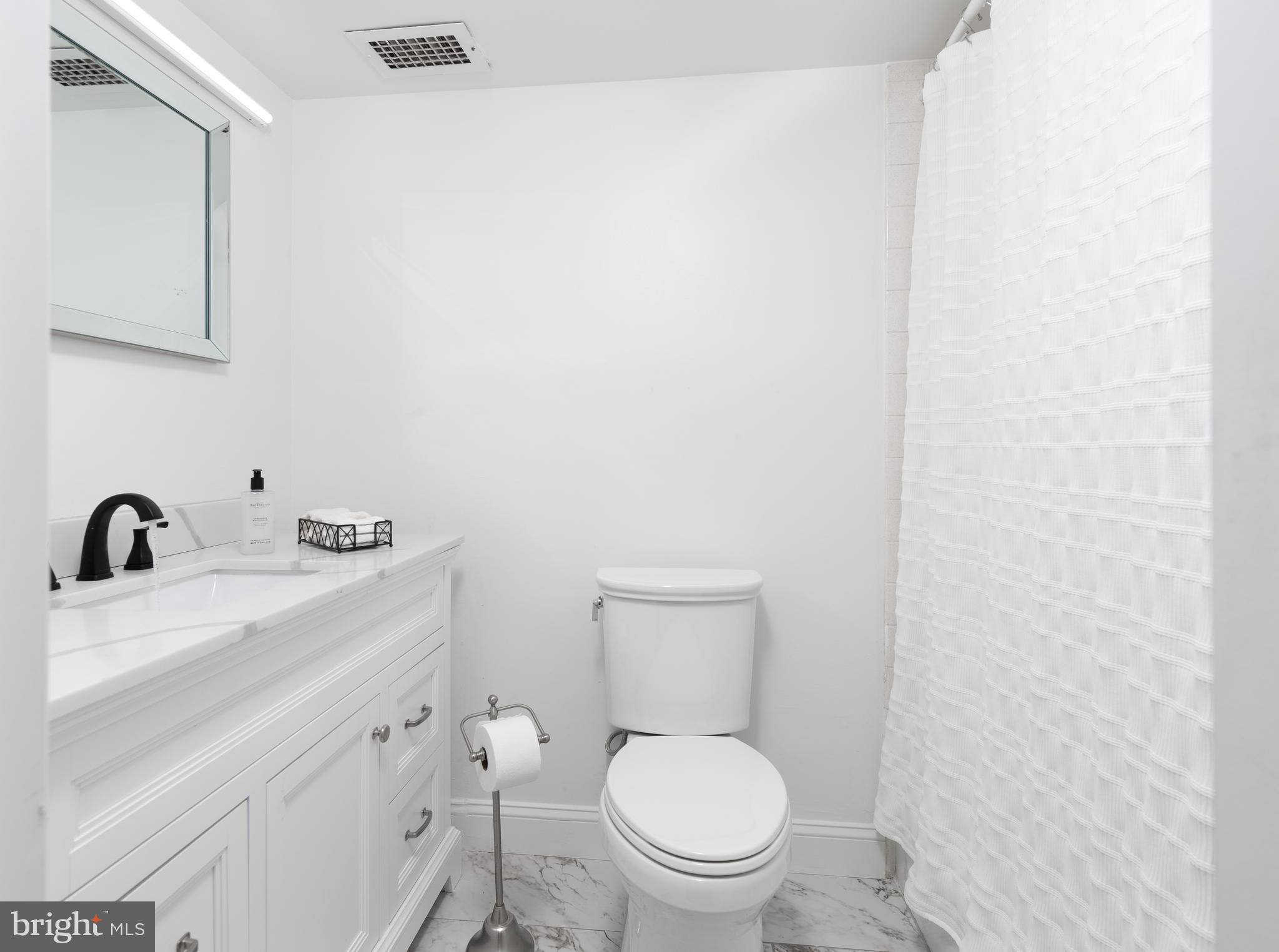 20 Conshohocken State Road, Unit 611 Bala Cynwyd, PA 19004 - Photo 17 of 25 a bathroom with a toilet sink vanity and mirror