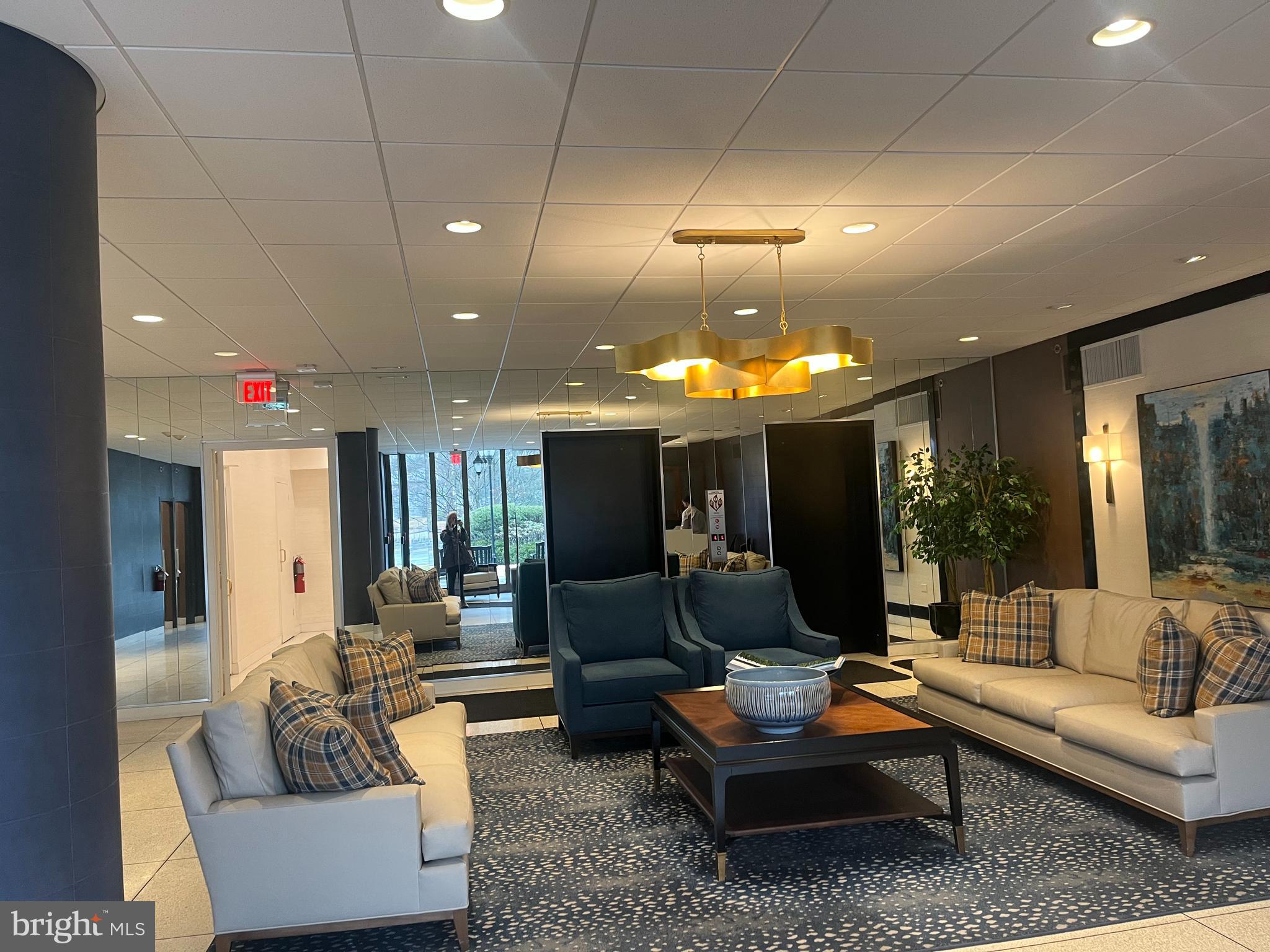 20 Conshohocken State Road, Unit 611 Bala Cynwyd, PA 19004 - Photo 20 of 25 a living room with furniture and a chandelier