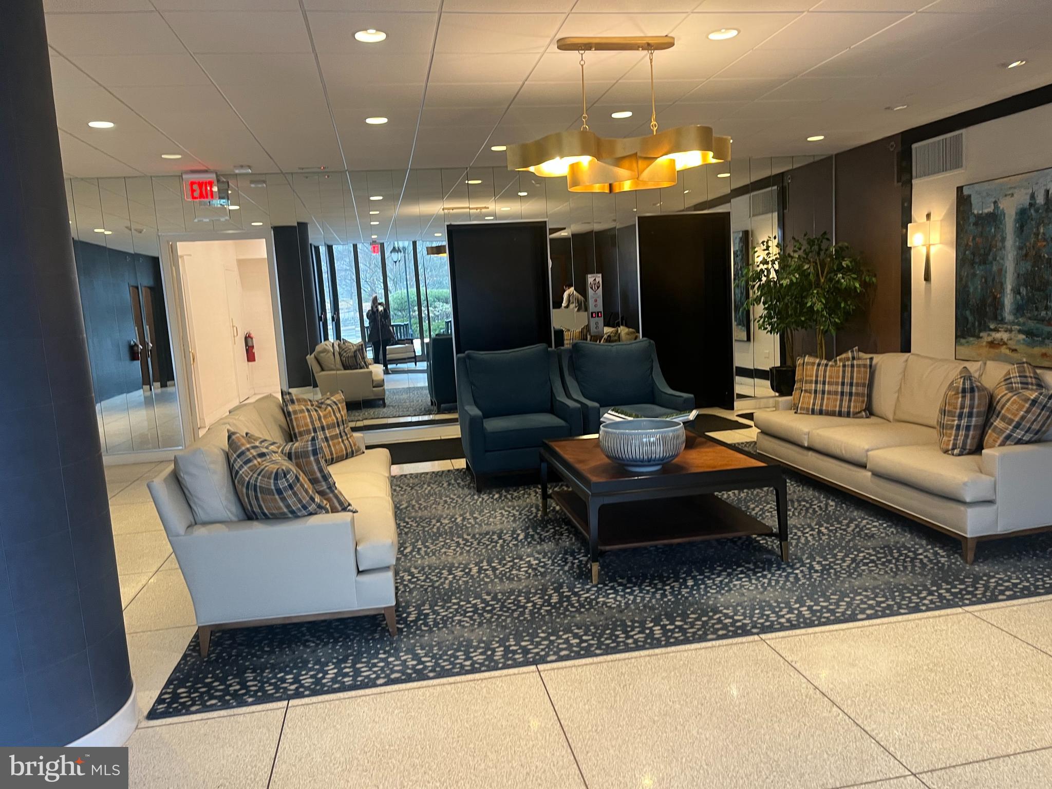20 Conshohocken State Road, Unit 611 Bala Cynwyd, PA 19004 - Photo 21 of 25 a living room with furniture and a chandelier