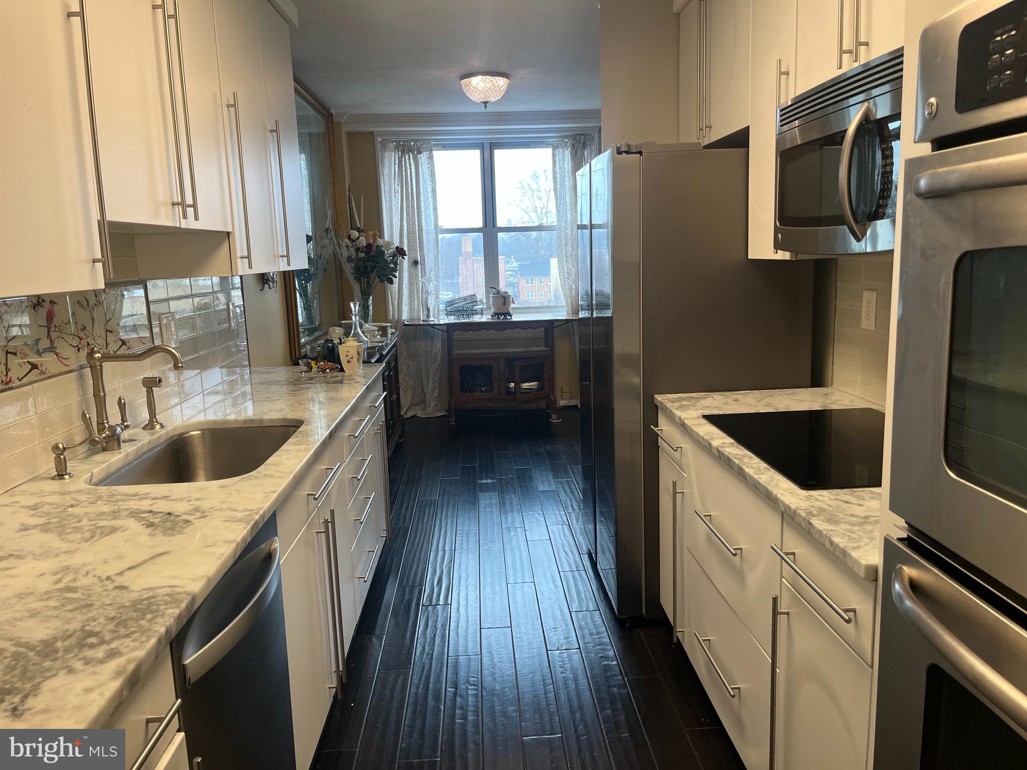 20 Conshohocken State Road, Unit 611 Bala Cynwyd, PA 19004 - Photo 7 of 25 a kitchen with a sink a refrigerator and cabinets