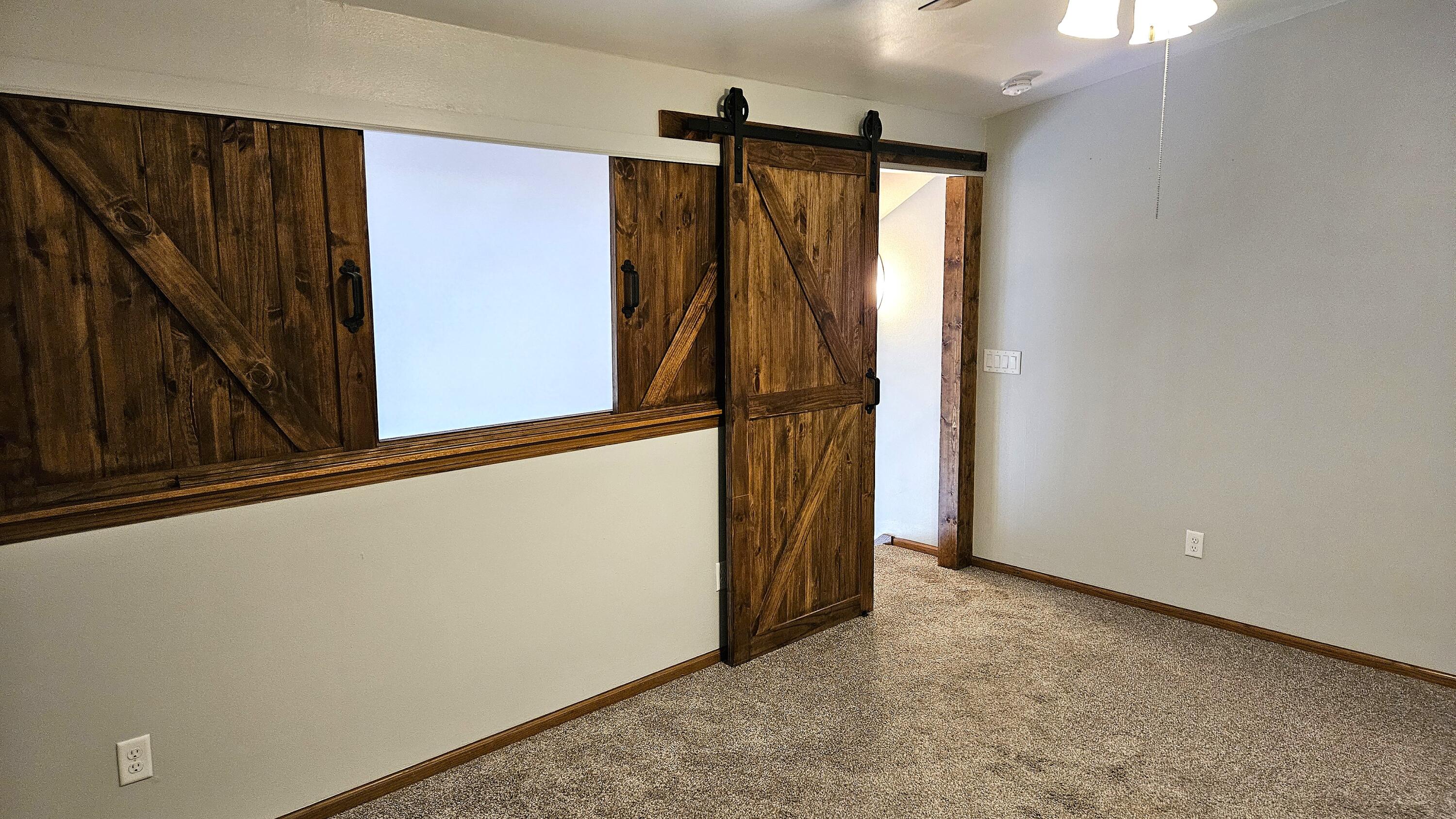 4887 Easy Street, Unit 11 Delafield, WI 53029 - Photo 18 of 26 Custom wood sliding panels isolate the upstairs Master Bedroom.